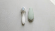 Two abstract handheld aesthetic devices compared on a clean studio surface