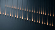 Abstract teardrop-shaped pulses of light representing Scarlet SRF short-pulse RF microneedling energy delivery