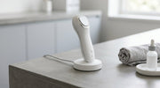 Modern handheld aesthetic device on a charging base in a clinical setting