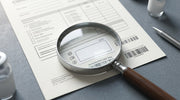Magnifying glass over a clinical document suggesting equipment verification